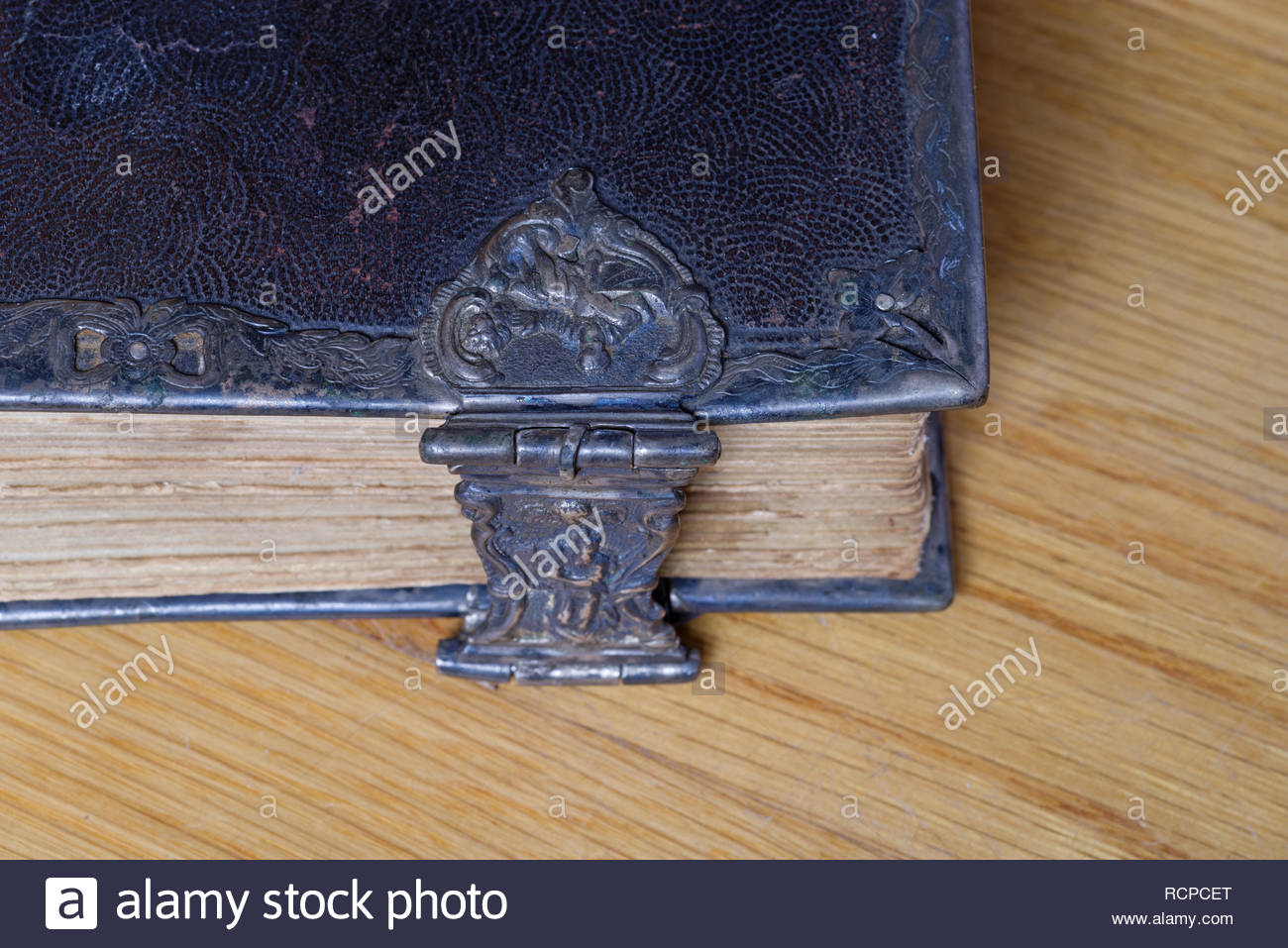corner-of-old-bible-with-metal-clasp-on-wood-RCPCET.jpg